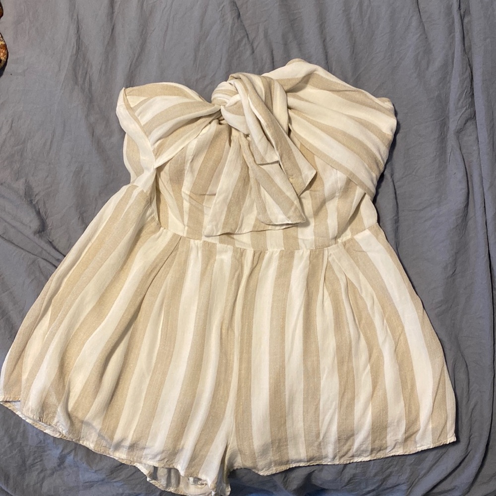 Adorable cream/white romper with front tie.